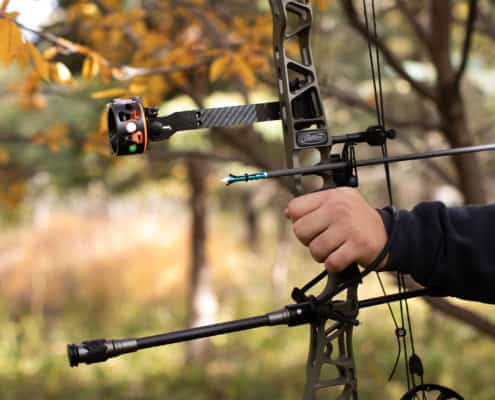 Bow being aimed with attached Dead Ringer Sight and Stabilizer
